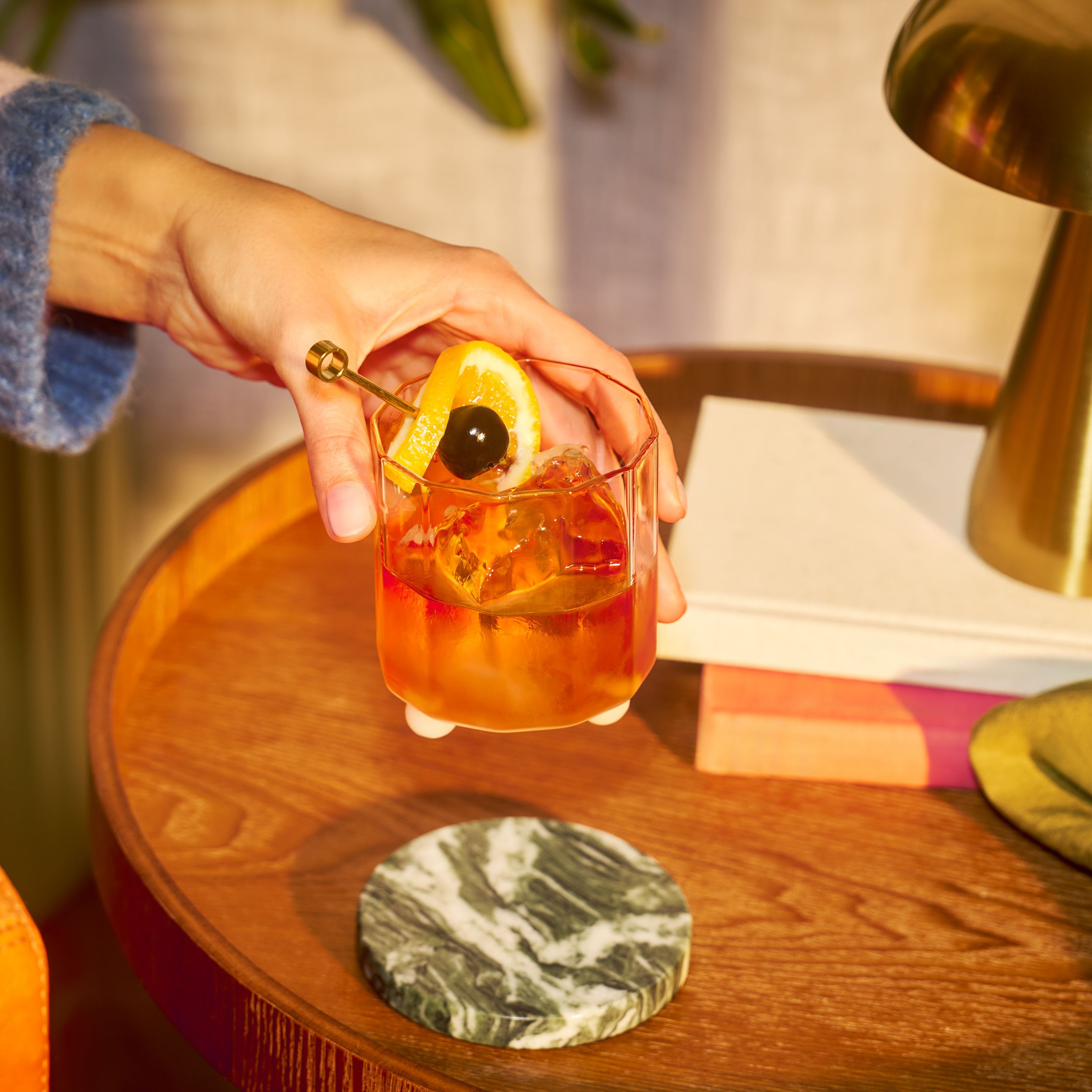 Woman enjoying an Old Fashioned cocktail