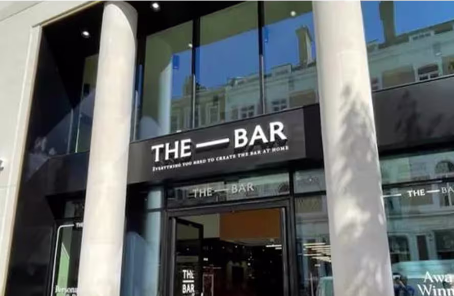 Exterior view of The Bar Store with its modern glass façade and sign above the entrance