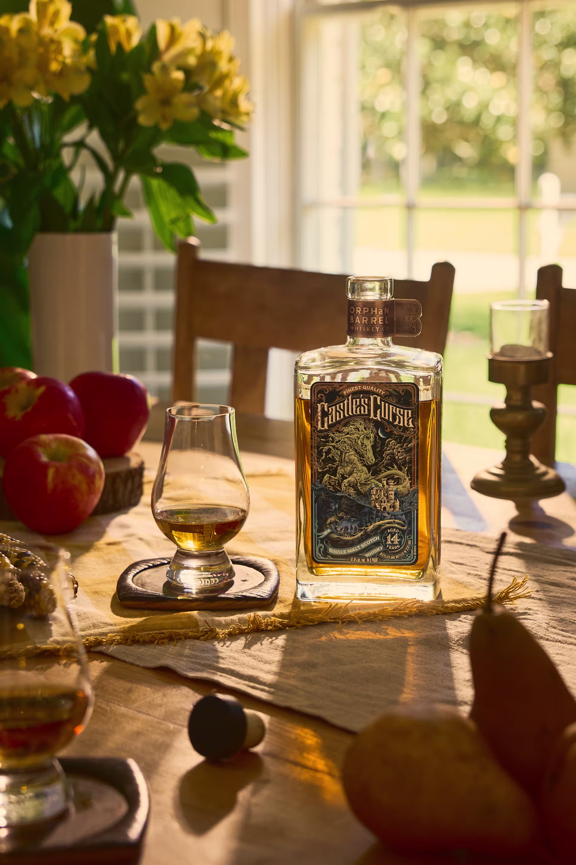 Person enjoying Orphan Barrel whiskey neat in a cozy home setting with vintage decor.