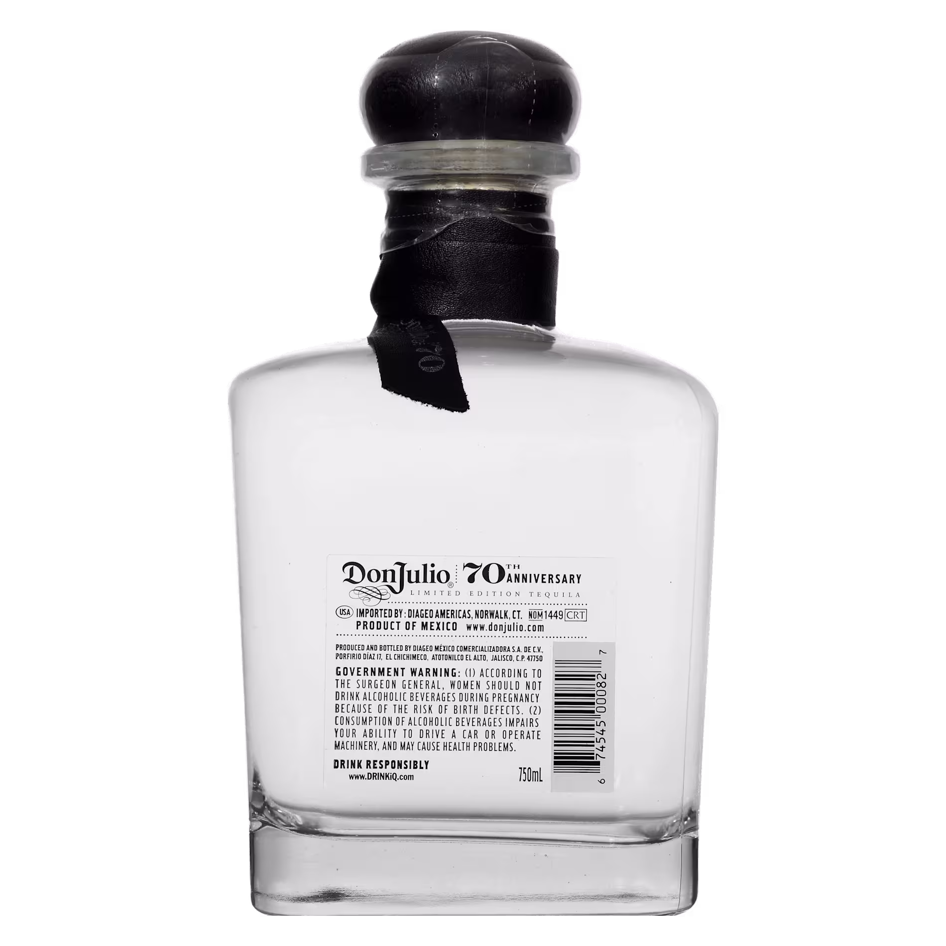 Clear glass bottle of Don Julio 70th Anniversary tequila, viewed from the back, showing the label and safety seal on the cap.