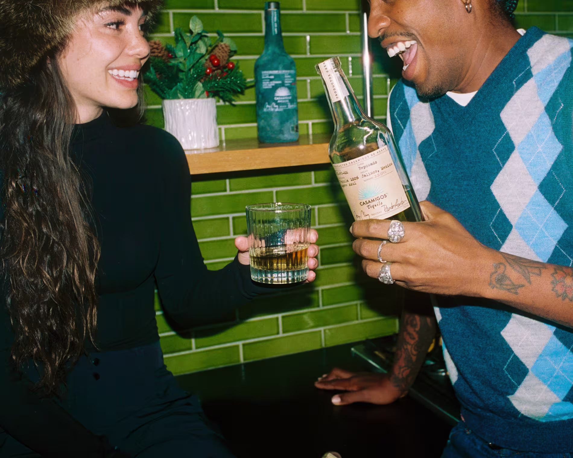 Friends enjoying a drink with Casamigos bottle in a vibrant social setting