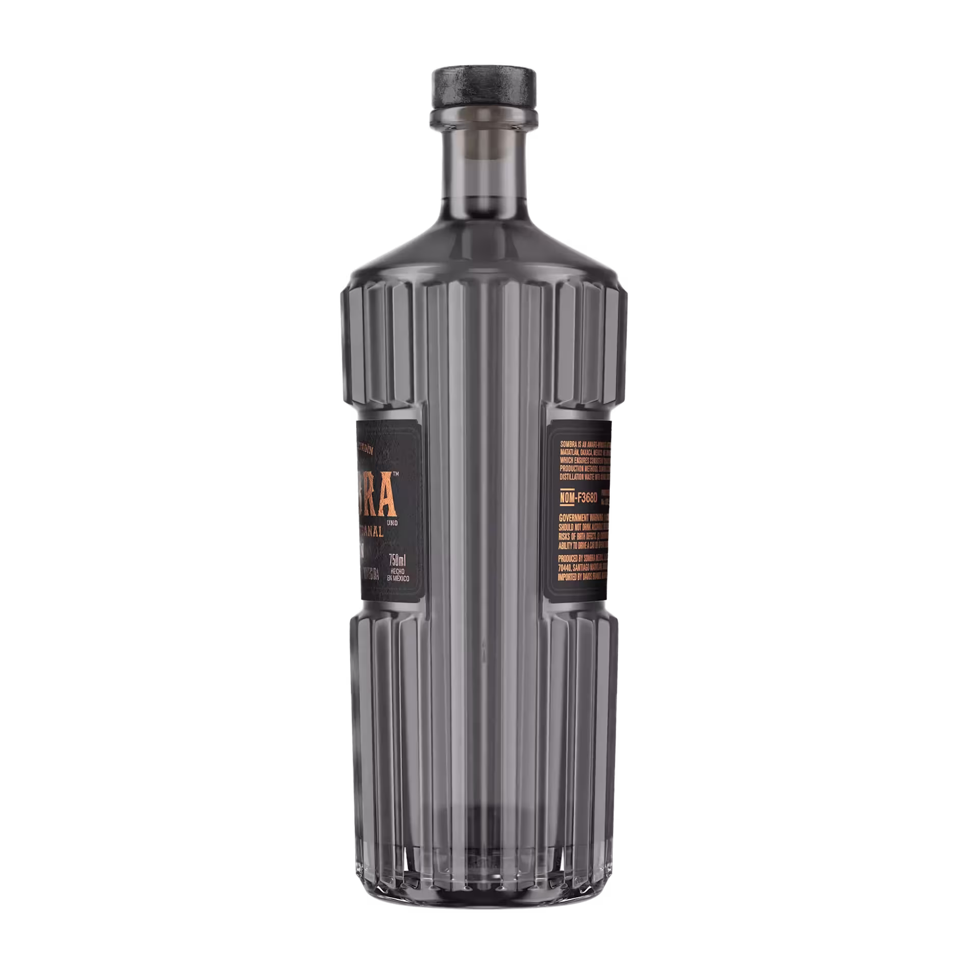 A tall, ridged, clear glass bottle with a black cap and black label featuring gold text, photographed against a plain background.