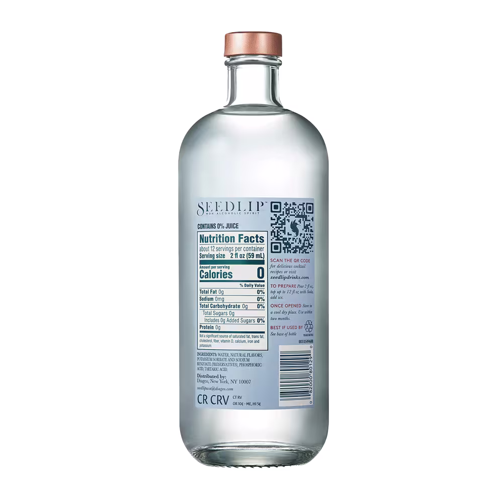 Clear glass bottle of Seedlip with a copper cap, displaying the nutrition facts label, barcode, and product information on the back.