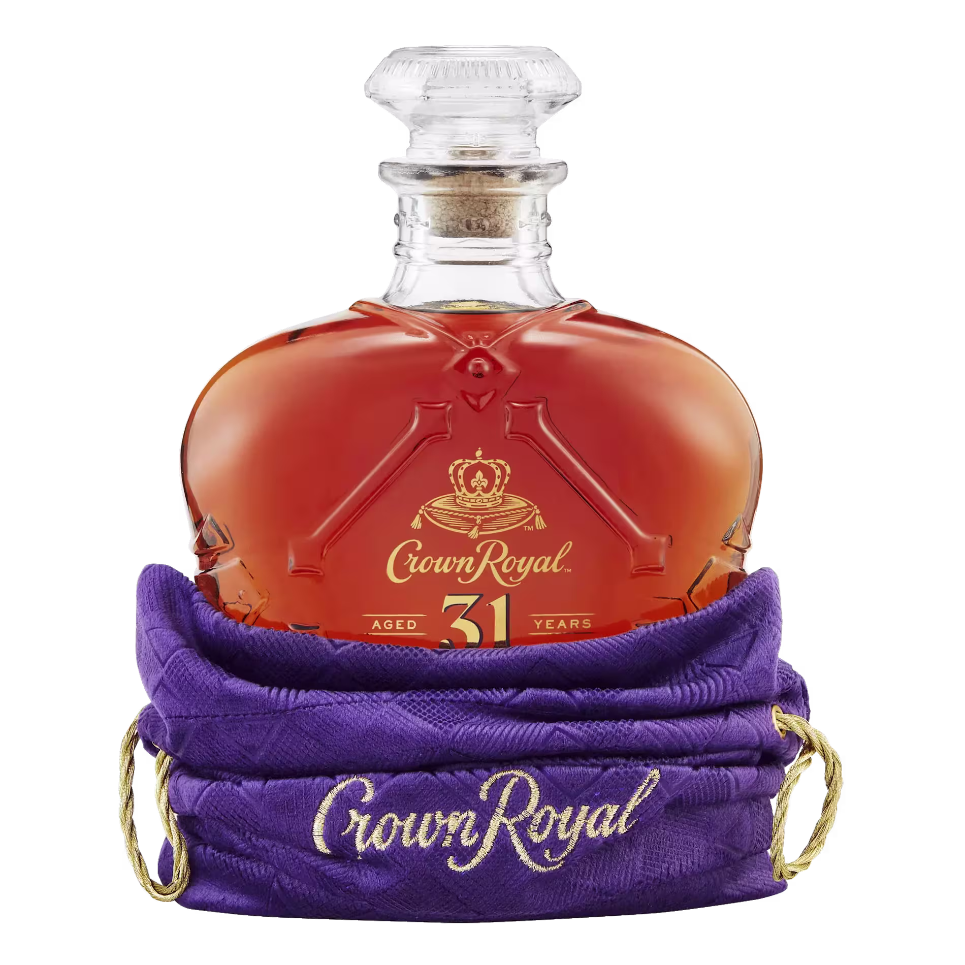 A bottle of Crown Royal 31 Year Old Canadian whisky in a purple bag embroidered with the Crown Royal logo.