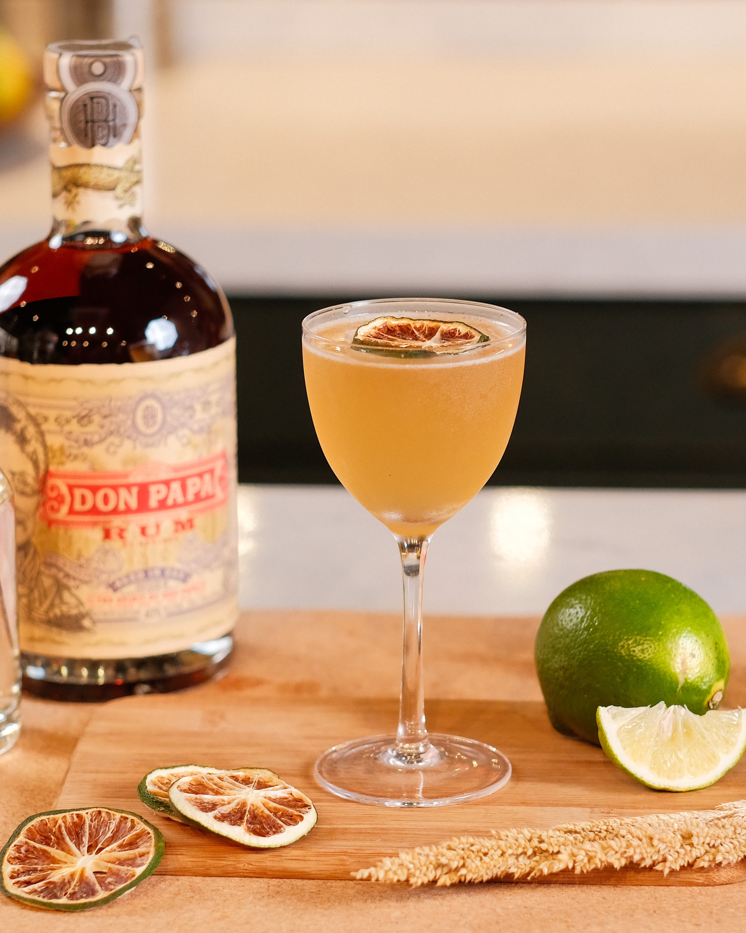 A daiquiri cocktail next to a bottle of Don Papa rum