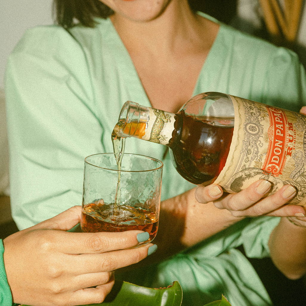 Close-up of Don Papa rum being poured from the bottle into a glass