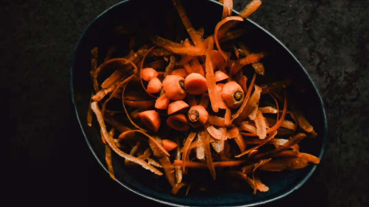 Bowl filled with carrot ends and peels
