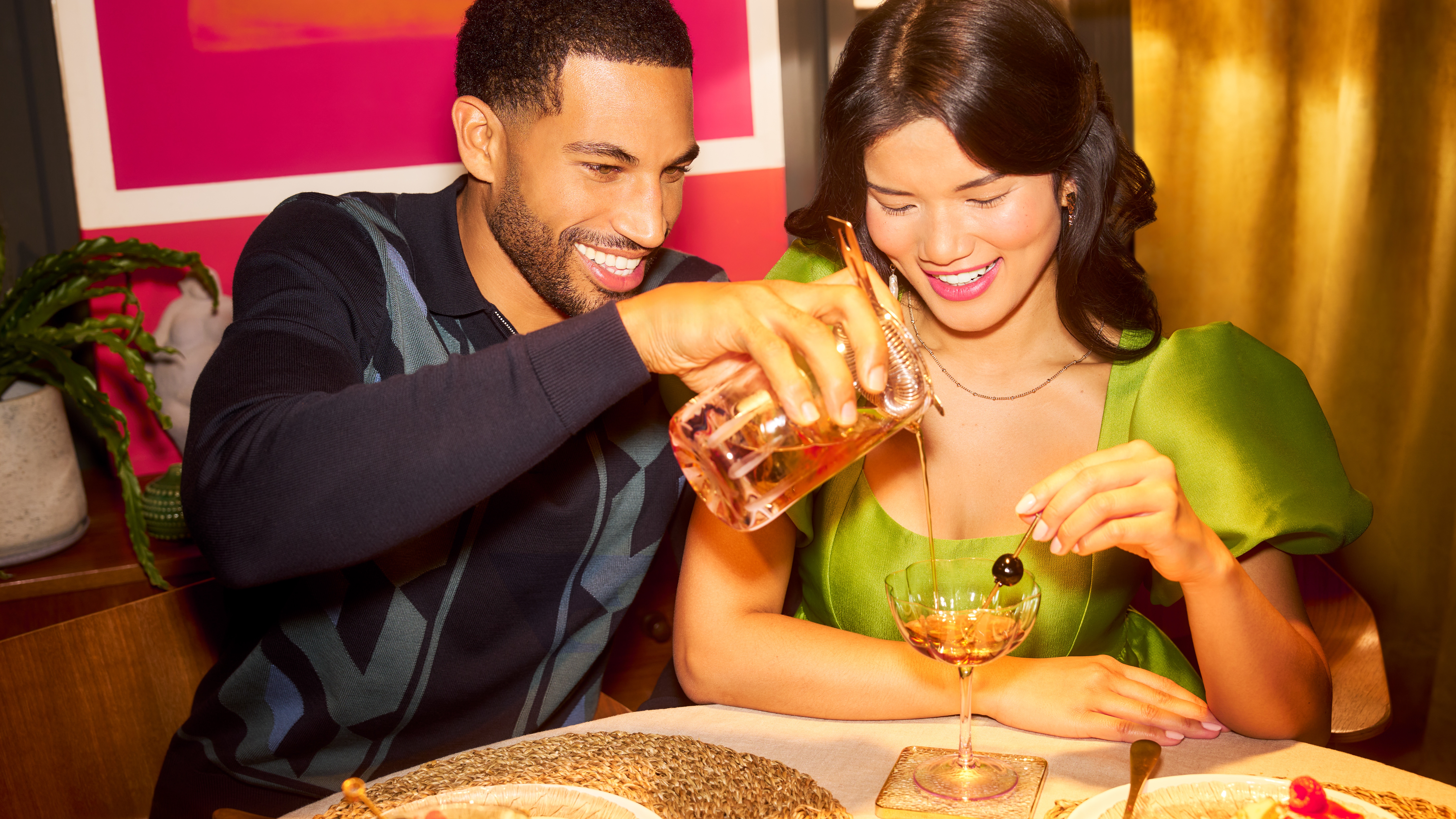 A couple enjoying a date night with cocktails and dessert