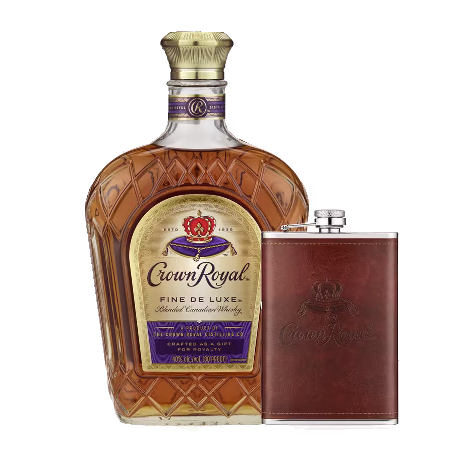 A bottle of Crown Royal Fine De Luxe Canadian Whisky next to a brown leather-wrapped flask with a Crown Royal logo.
