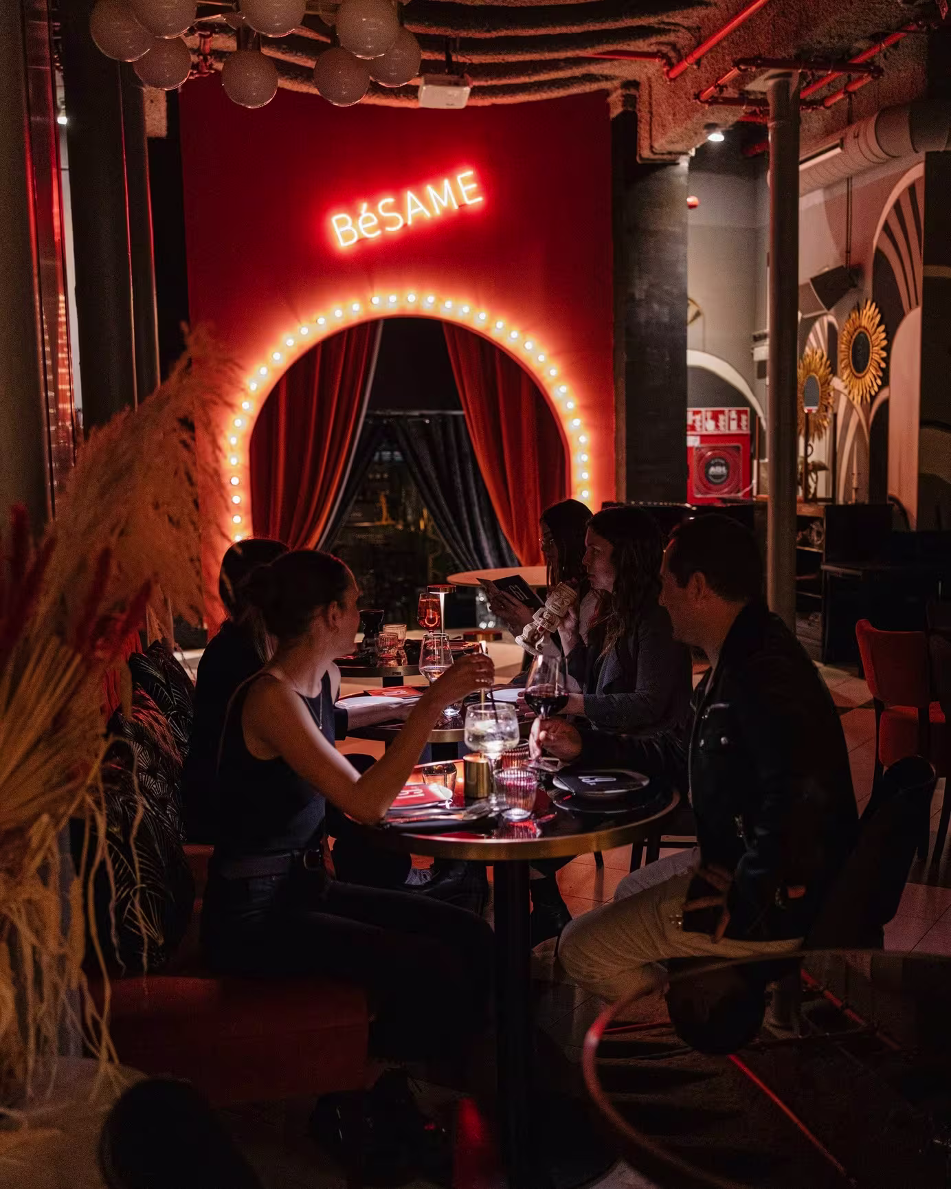 Cena en Club 61 bajo el letrero “Bésame”, en un ambiente cálido y romántico perfecto para compartir momentos especiales.