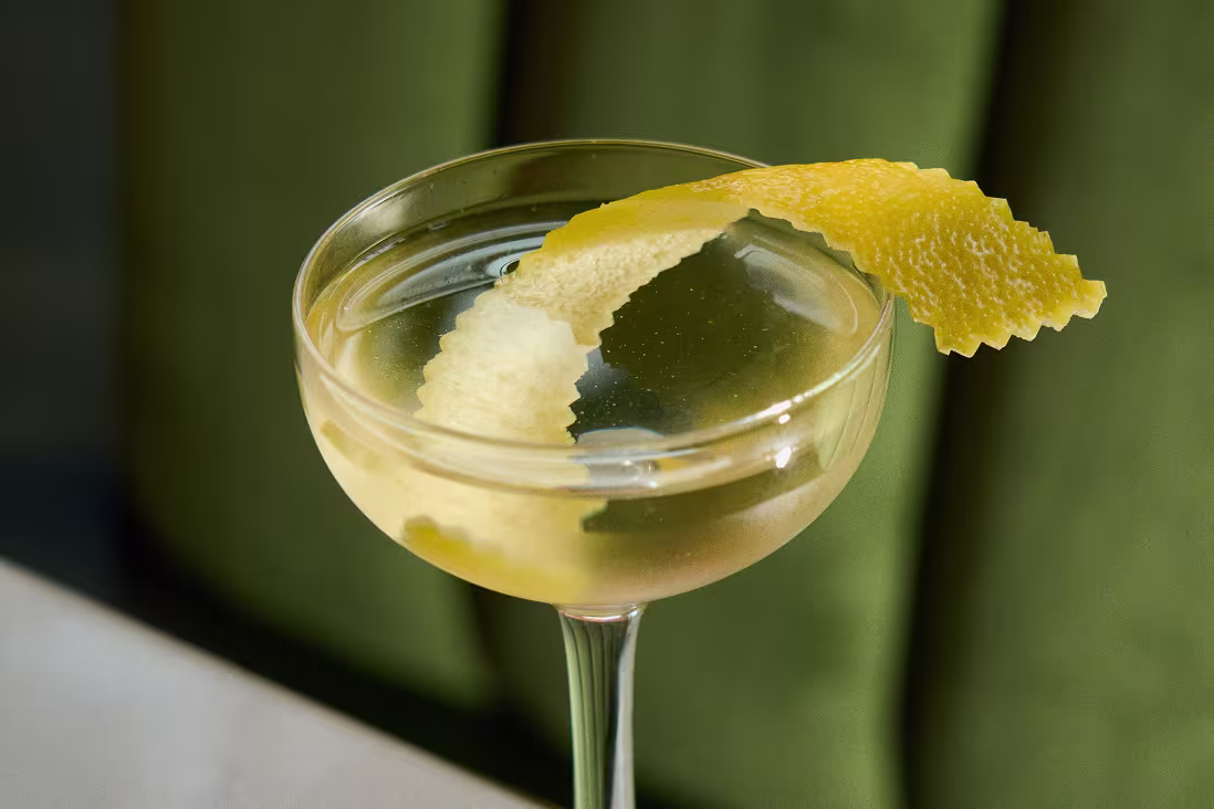 Vodka martini in a coupe glass garnished with an olive