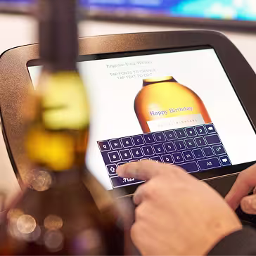 Customizing a bottle with a personal message using an engraving screen at The Bar Store