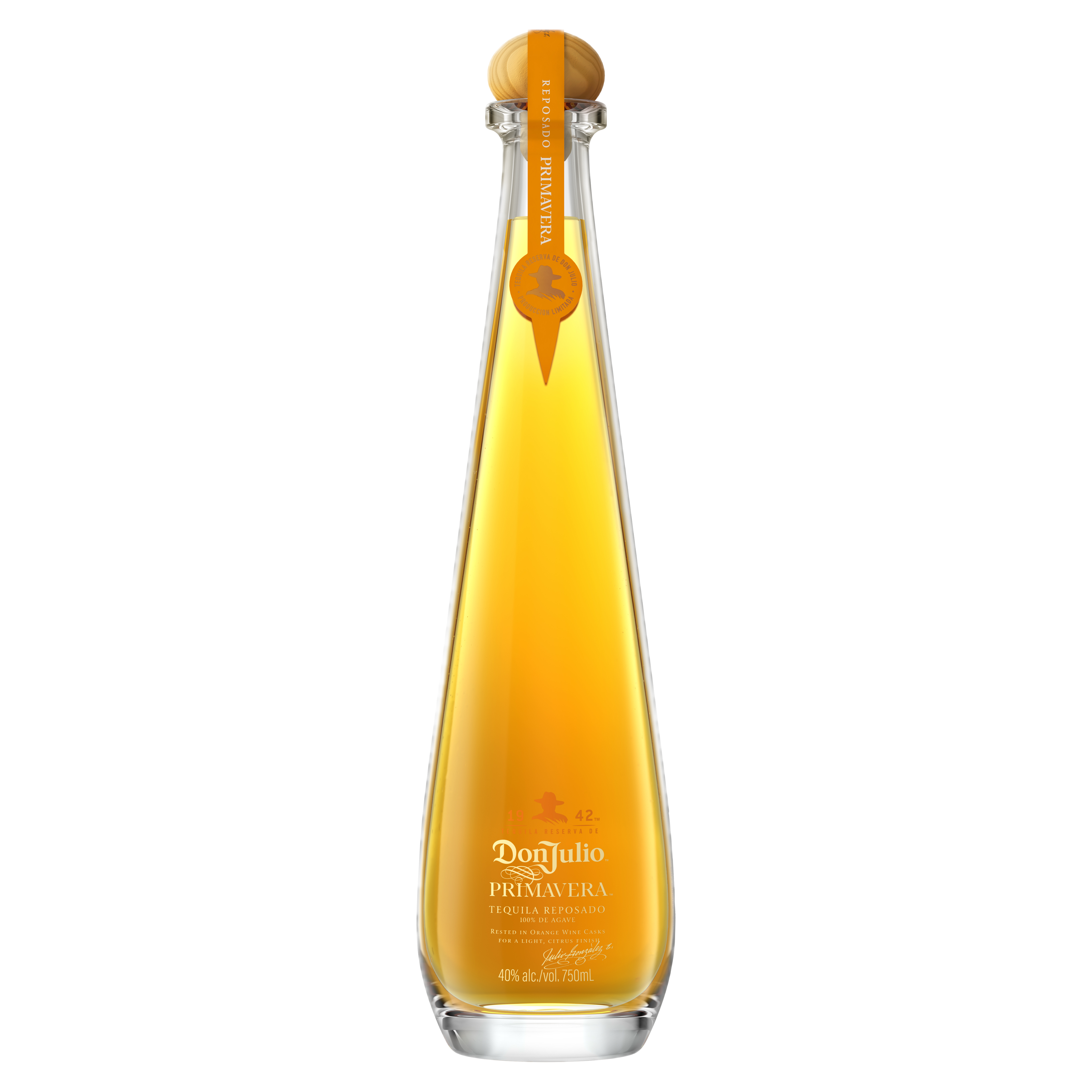 A tall, clear glass bottle of Don Julio Primavera tequila with a rounded cork top and orange label accents, filled with golden liquid.