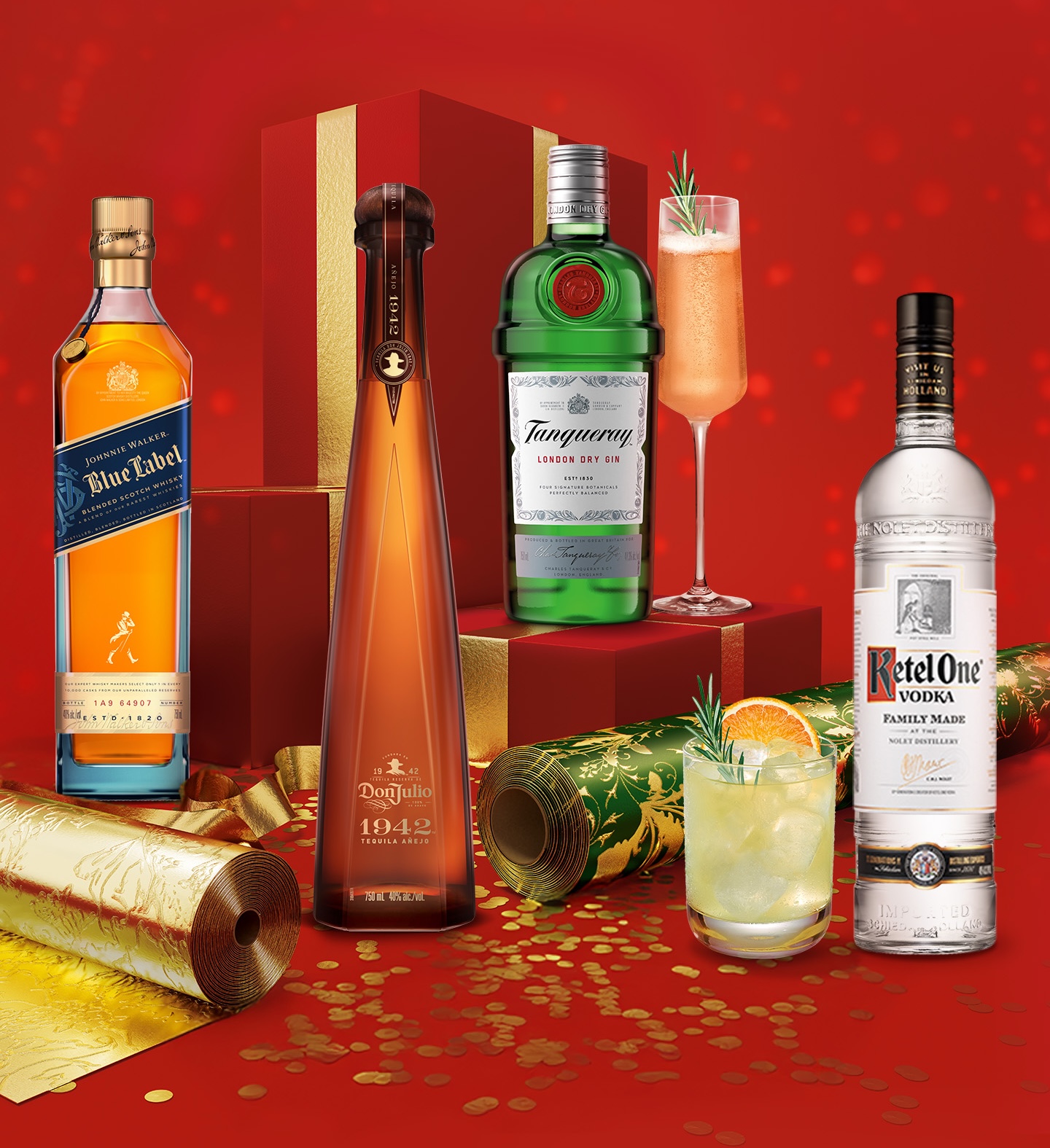 Four bottles of premium spirits and two cocktails are arranged on a festive red background with gold decorations and wrapped gift boxes.