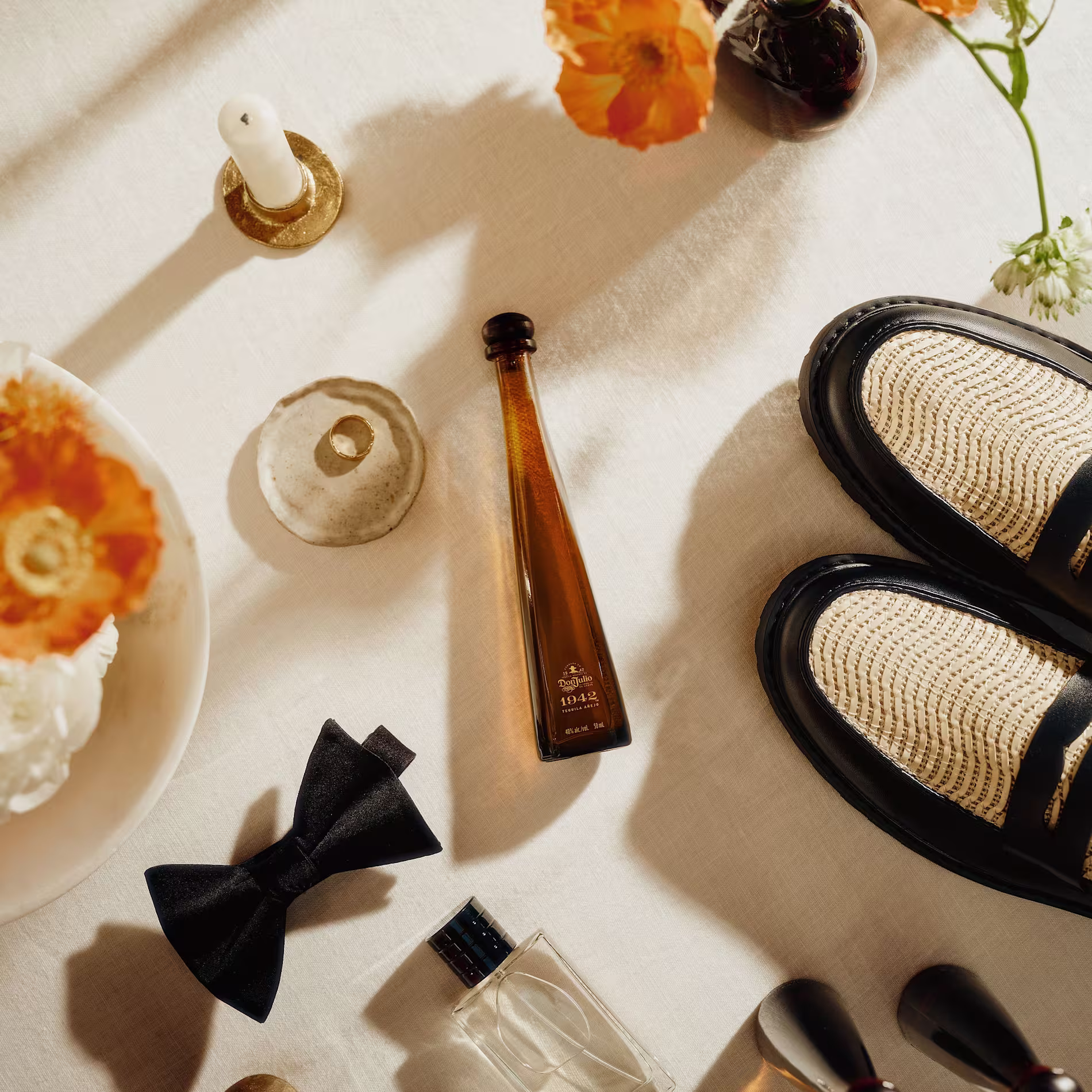 Don Julio 1942 next to a pair of shoes