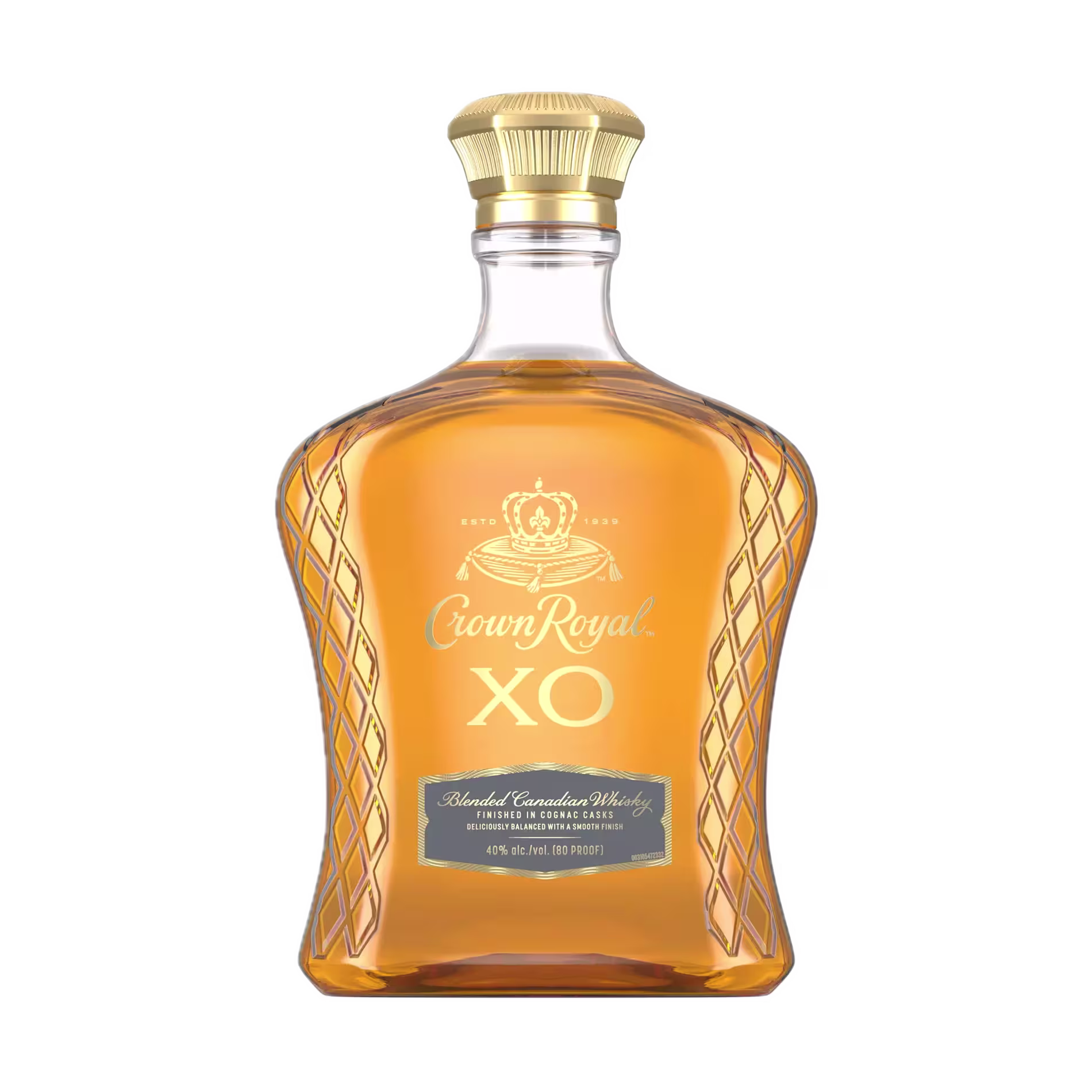 A clear glass bottle of Crown Royal XO blended Canadian whisky with a gold cap and label, filled with amber-colored liquid.