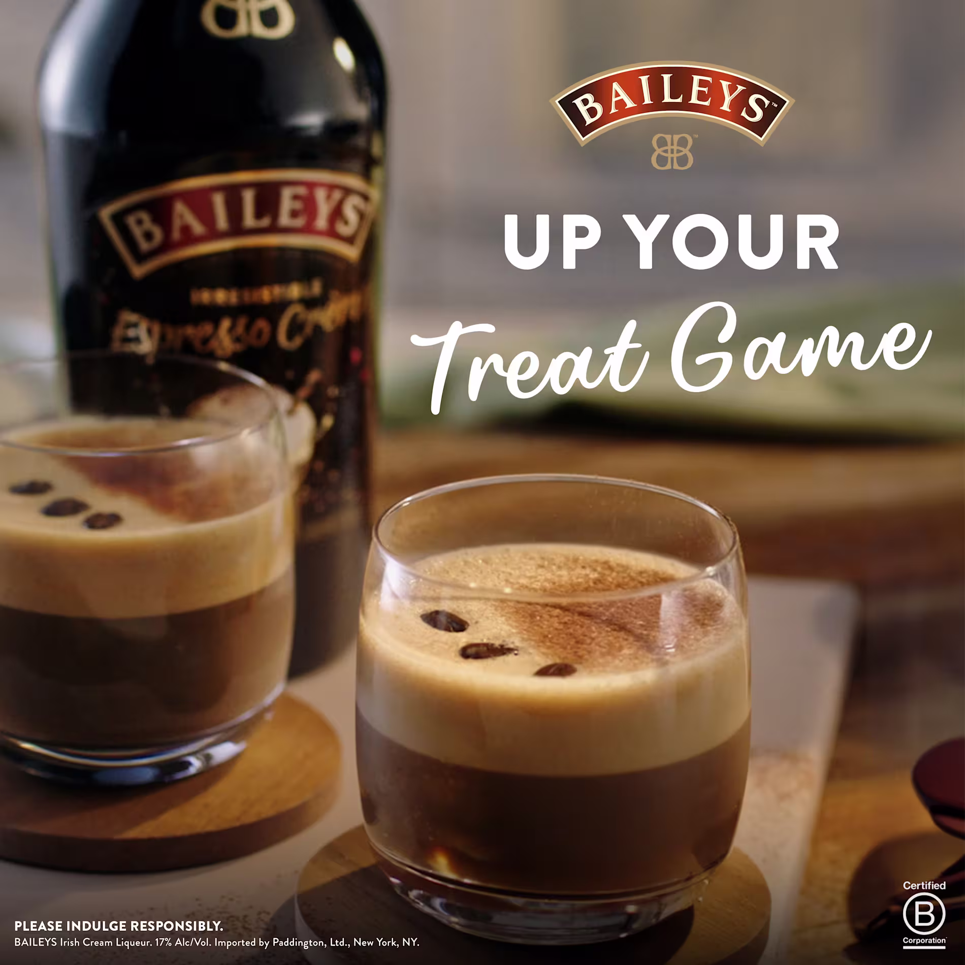Two glasses of Baileys espresso cocktails sit on a table with a bottle of Baileys Espresso Creme in the background. Text reads, UP YOUR Treat Game.