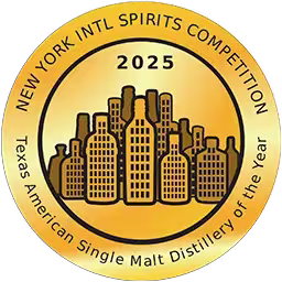 Gold circular award badge with bottle shapes in the center, labeled 2025 New York Intl Spirits Competition - Texas American Single Malt Distillery of the Year.
