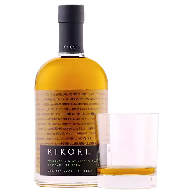 A bottle of Kikori whiskey next to a glass containing a small pour of whiskey, both set against a plain background.