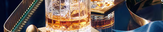 Prim plan al whisky-ului Johnnie Walker servit în pahare de cristal pe un aranjament luxos
