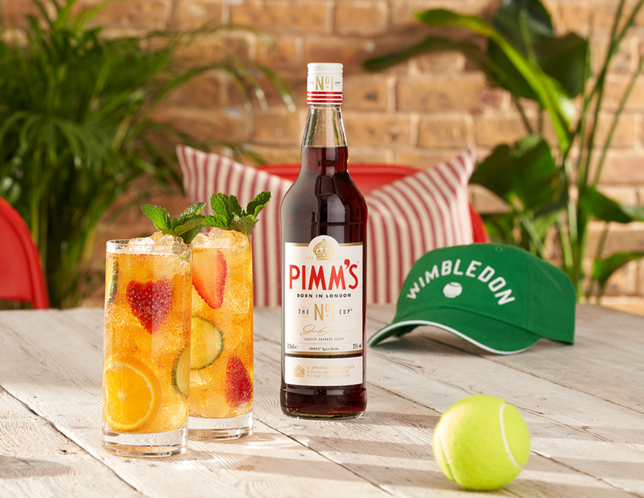 A bottle of Pimm's next to a tennis racket
