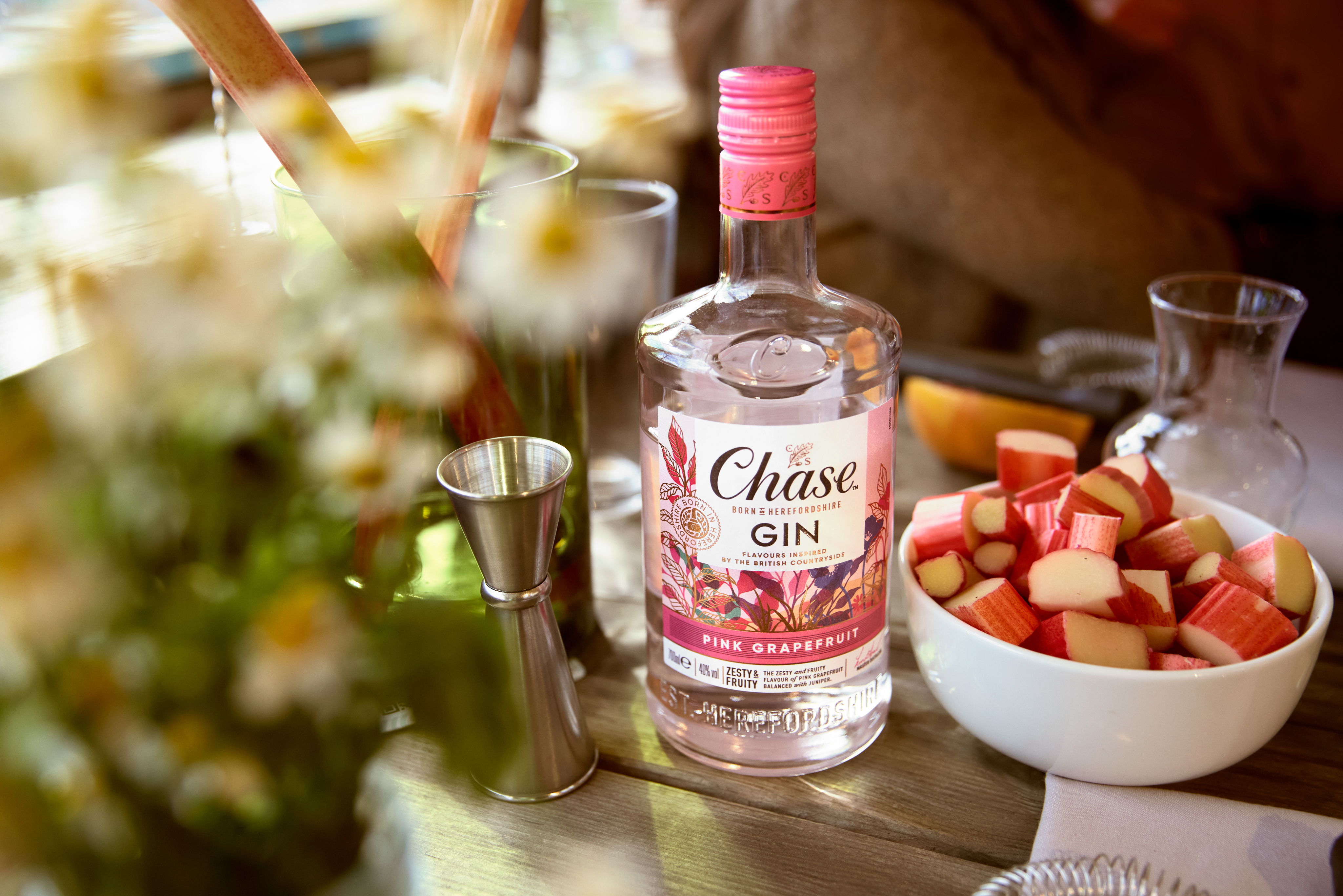 Host passing around tray with Chase Pink Grapefruit & Pomelo gin bottle and cocktails
