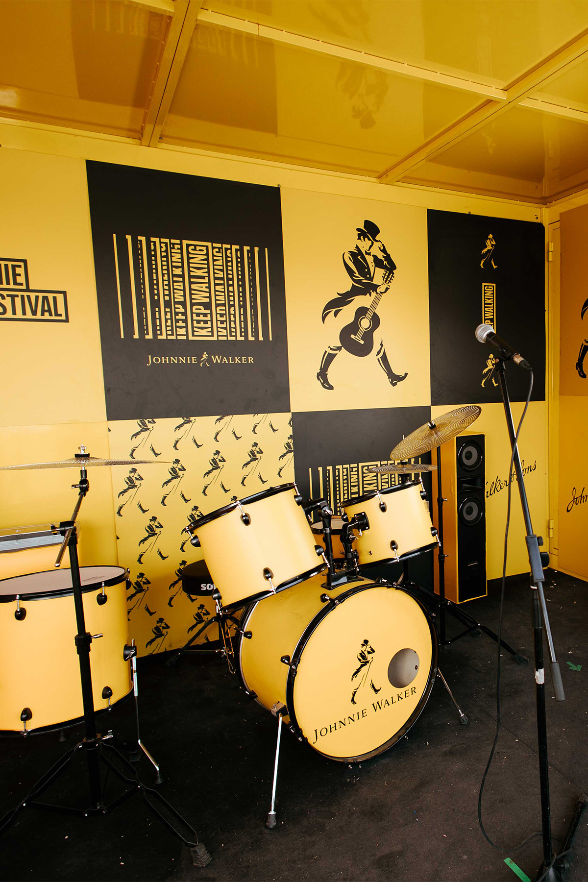 johnnie walker themed recording room with drum and electric guitar