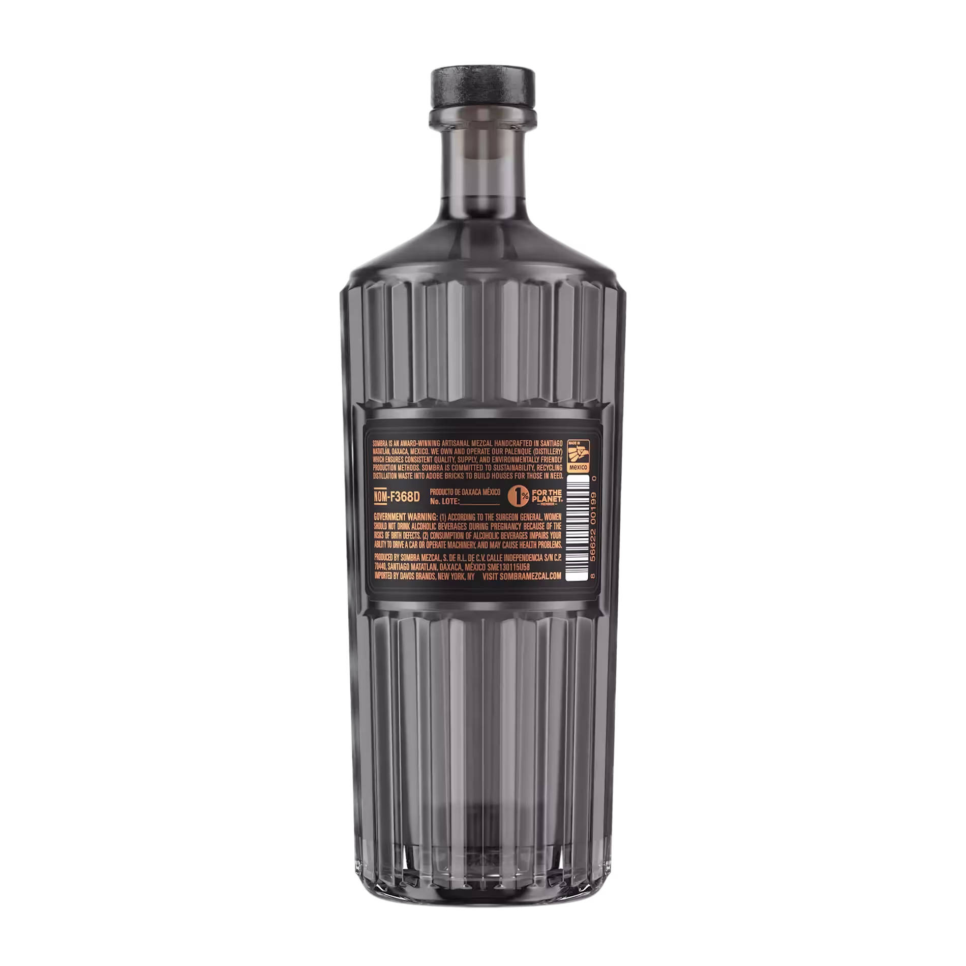 A clear, tall, faceted glass bottle with a black cap shown from the back, featuring an orange and white label with product information.