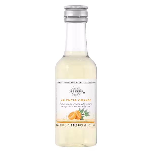 A clear glass bottle of 21 Seeds Valencia Orange tequila with a silver cap and a white label featuring orange illustrations.