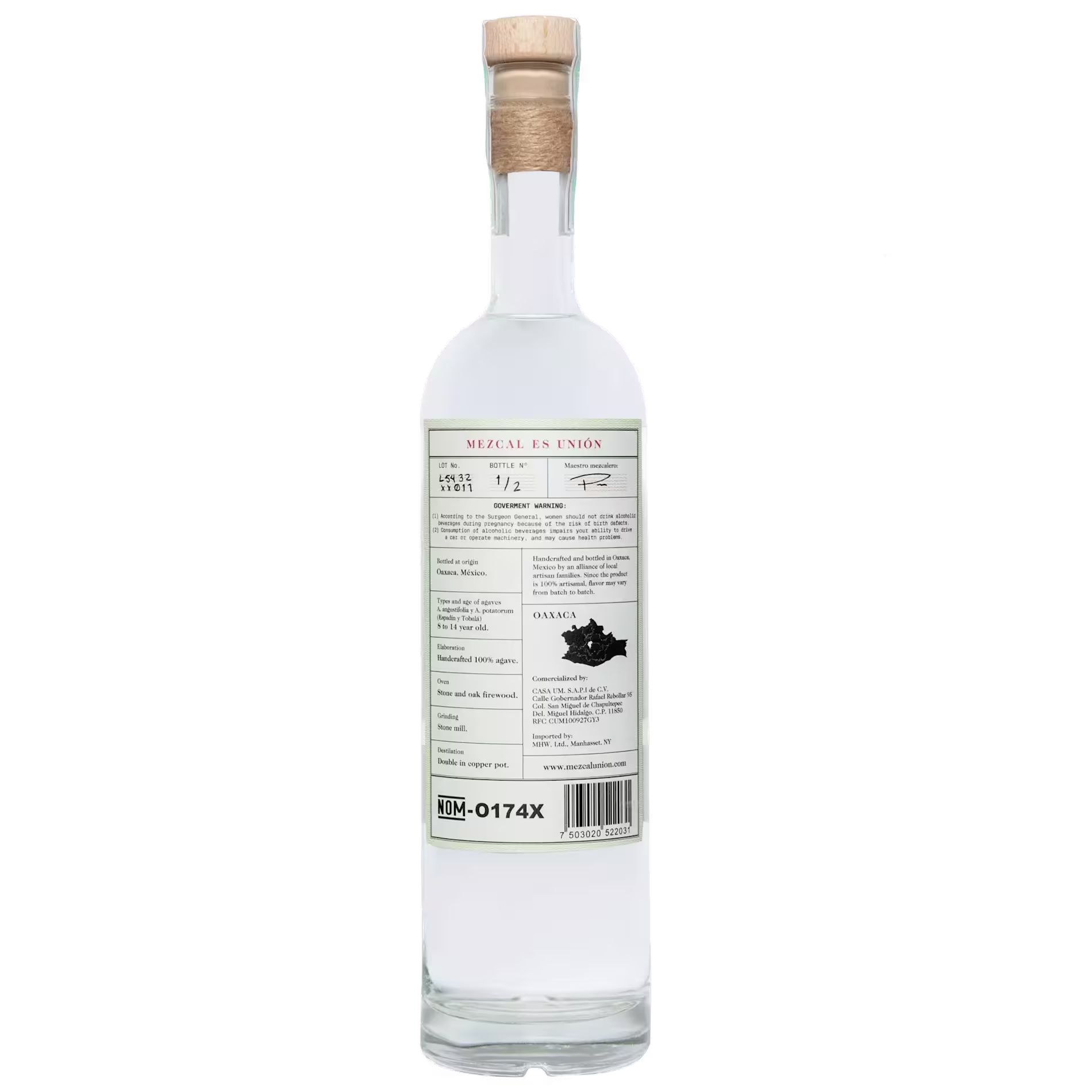 A clear glass bottle of Mezcal Unión with a cork stopper, showing the back label containing product details and a map of Oaxaca, Mexico.