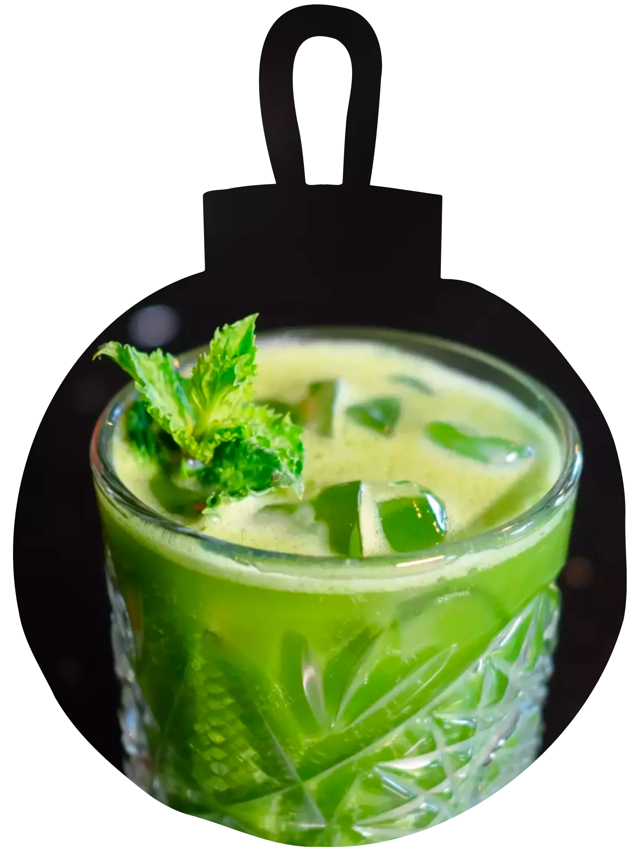 A glass of green juice with ice cubes and a sprig of mint, served in a textured glass.