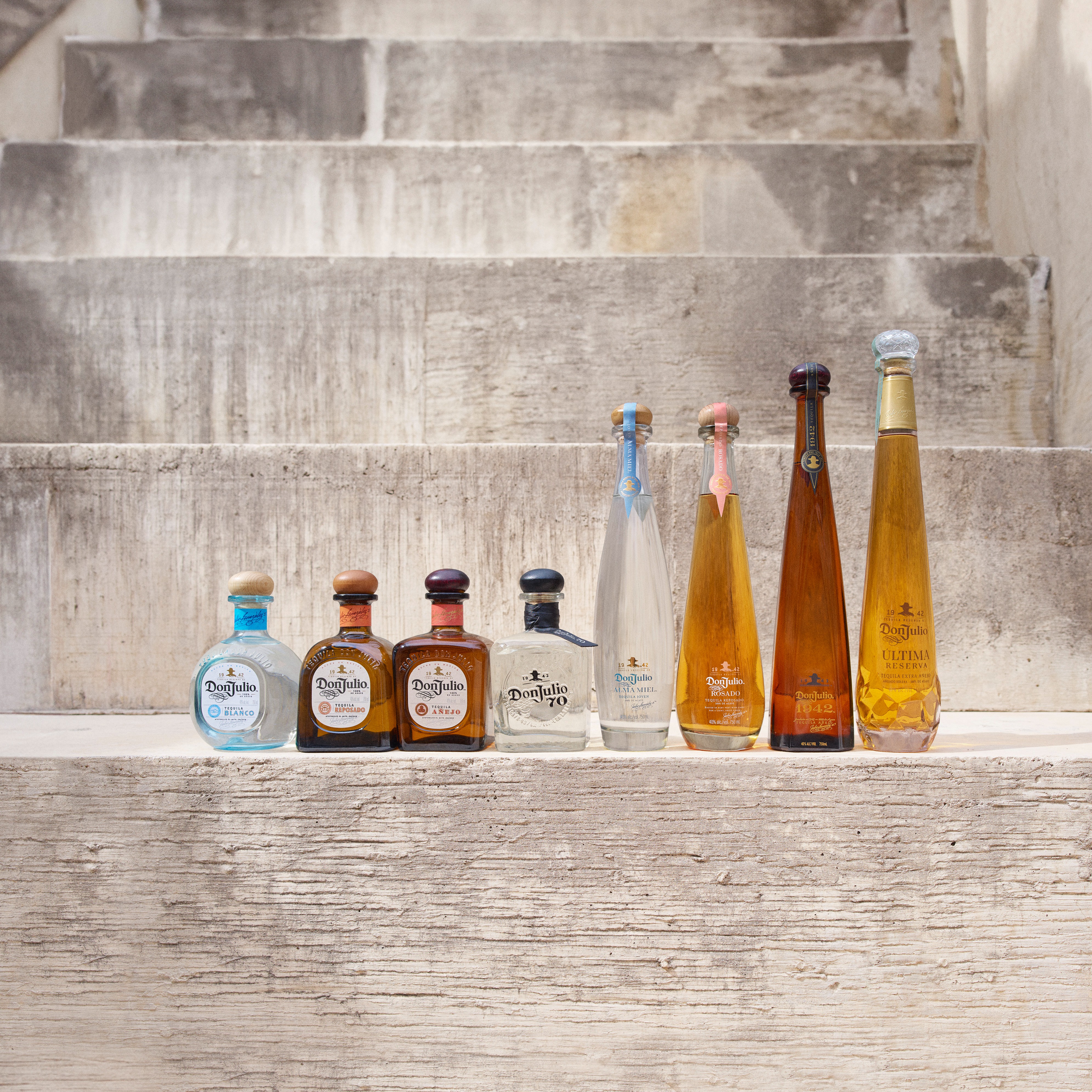 A bottle of Don Julio next to two Paloma cocktails.
