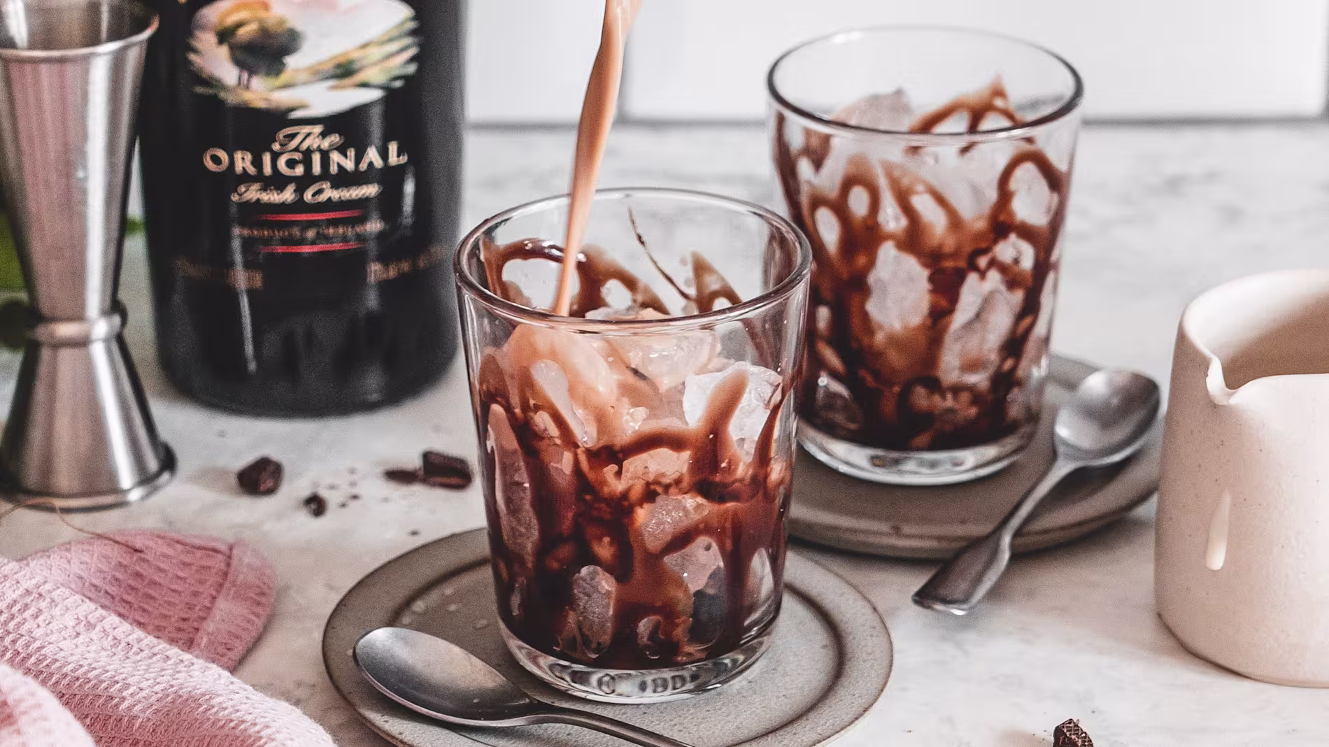 A picture of a Baileys Mudslide cocktail, with the glass drizzled in chocolate