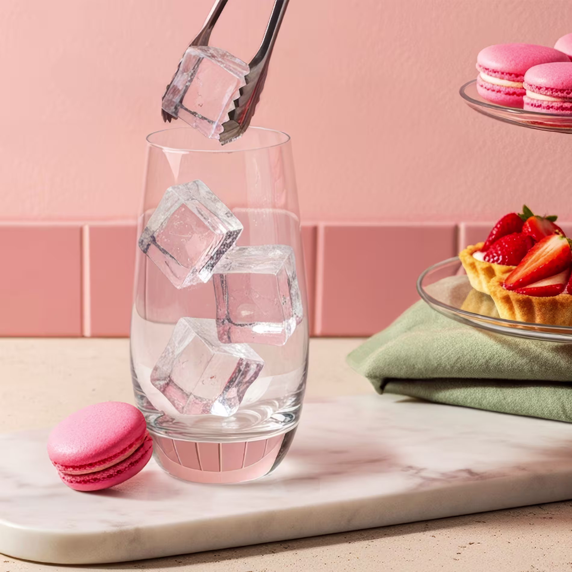 Ice being added to a highball glass