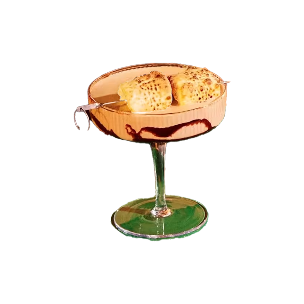 Baileys S’mores Tini cocktail served in a coupe glass with a chocolate drizzle around the rim and toasted marshmallows skewered across the top. The creamy, dessert-inspired martini is shown from two angles against a transparent background.