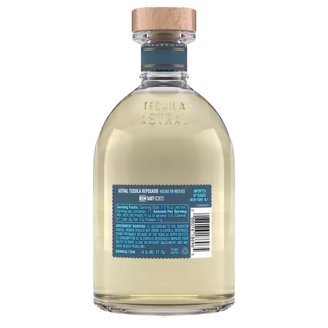 A bottle of Astral Tequila Reposado with a wooden cap, shown from the back displaying the label with product and nutrition information.