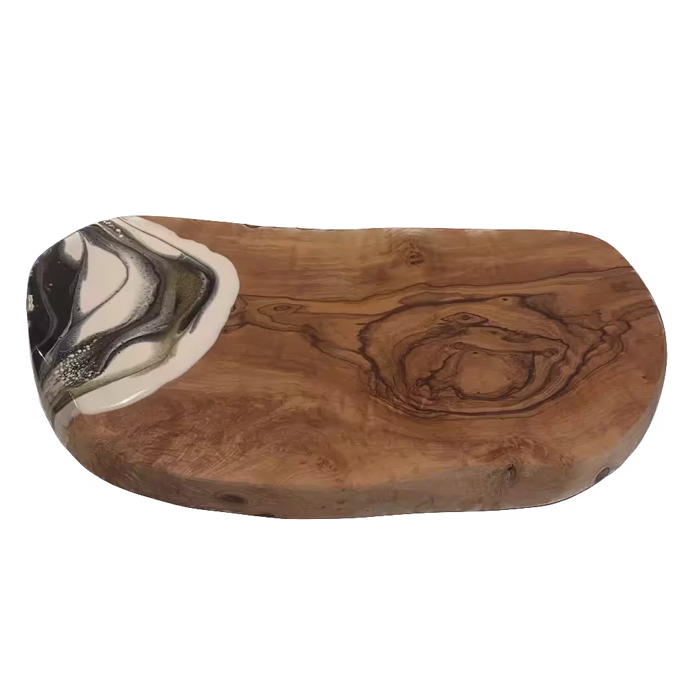 A rectangular wooden serving board with natural grain patterns and one corner decorated with white and metallic resin.