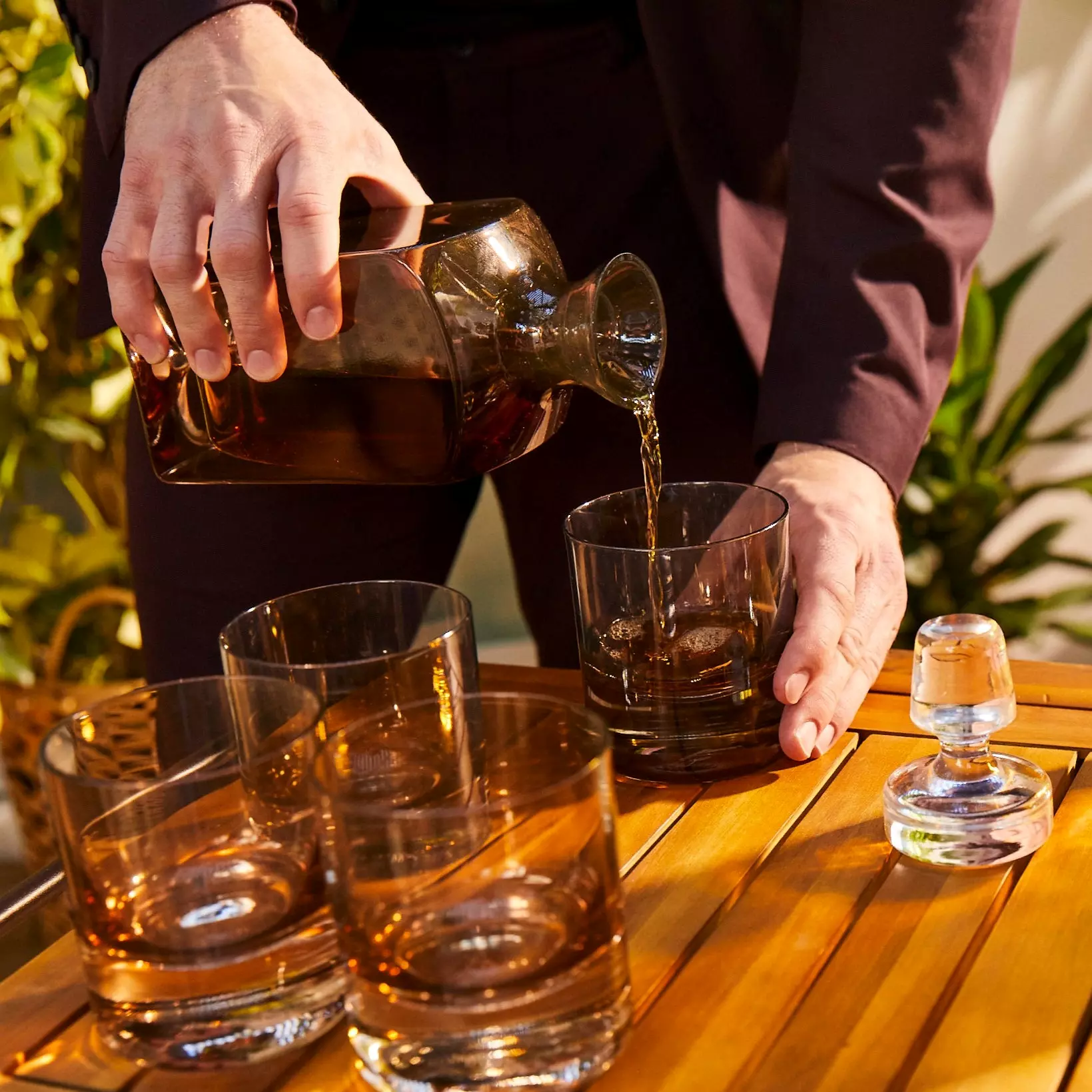 A man pouring a drink to a glass