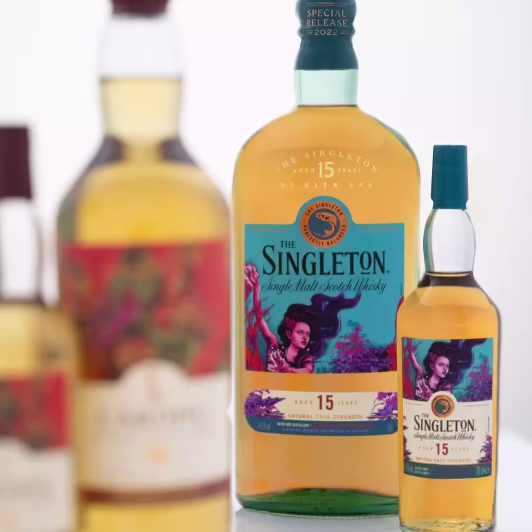 Three bottles of whisky are shown, with the largest featuring a colorful label reading The Singleton 15 and smaller bottles partially visible around it.
