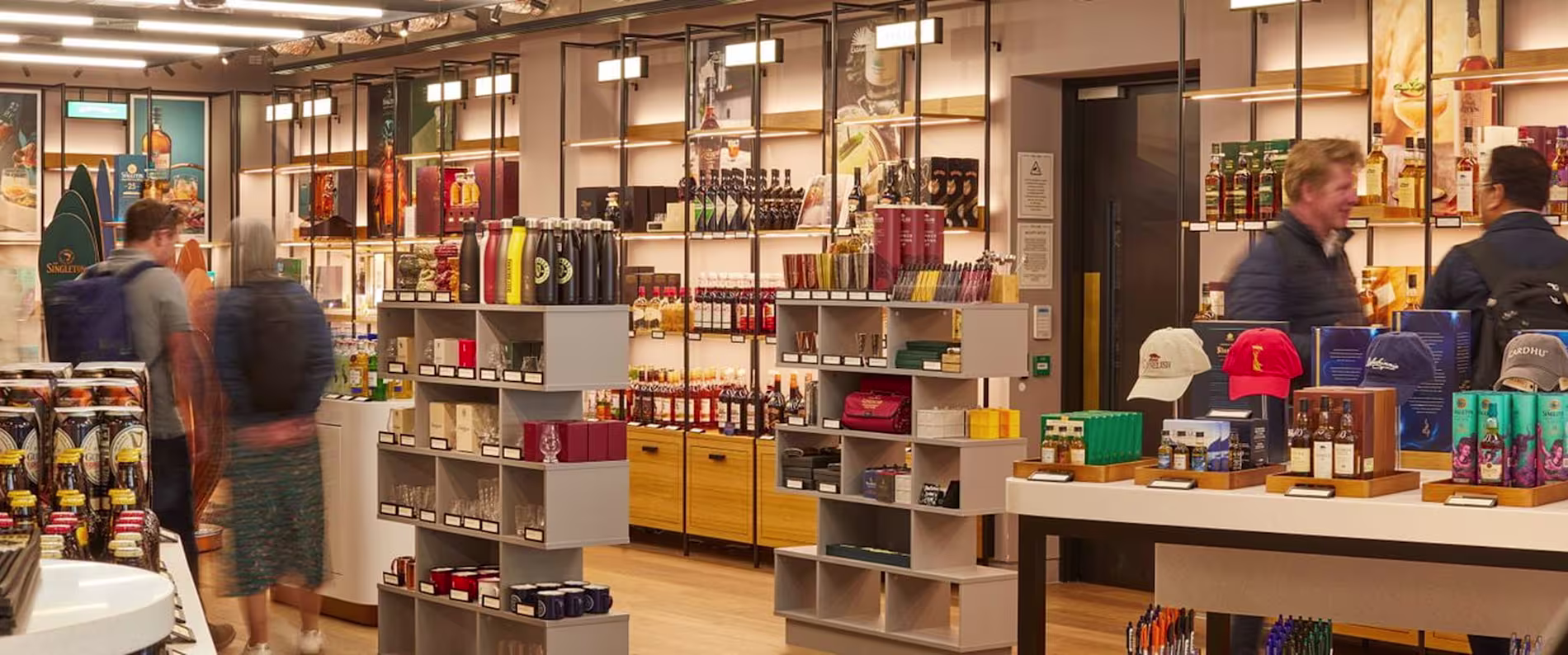 Inside view of The Bar Store, showcasing shelves with bottles, glassware, and gifts