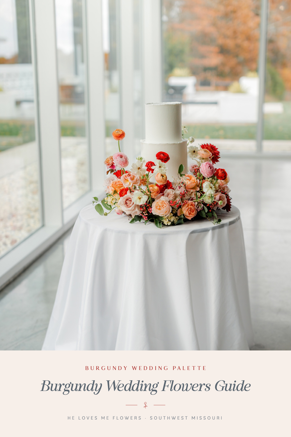 Burgundy wedding flowers guide with red and peach flowers on a table