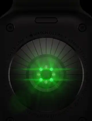 Back of Apple Watch Ultra 4, titanium case, black colour, multiple round sensors with glowing green LED lights