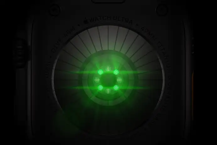 Back of Apple Watch Ultra 4, titanium case, black colour, multiple round sensors with glowing green LED lights
