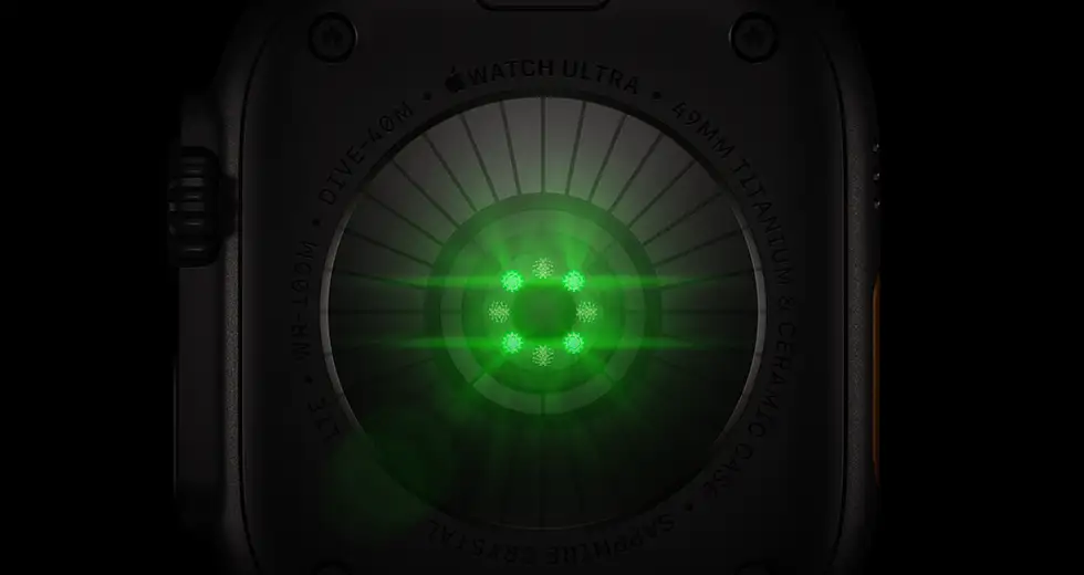 Back of Apple Watch Ultra 4, titanium case, black colour, multiple round sensors with glowing green LED lights