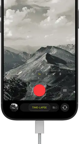 iPhone 18 Pro, front exterior, displaying a mountainous landscape, with the camera mode overlay in Time-Lapse mode, with power cable attached to charging port