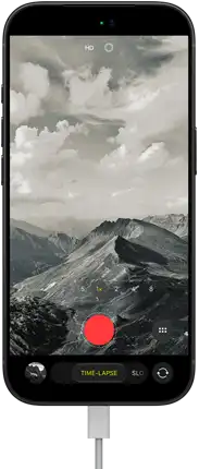 iPhone 18 Pro, front exterior, displaying a mountainous landscape, with the camera mode overlay in Time-Lapse mode, with power cable attached to charging port