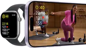Apple Watch next to iPhone with Apple Fitness+ class on screen