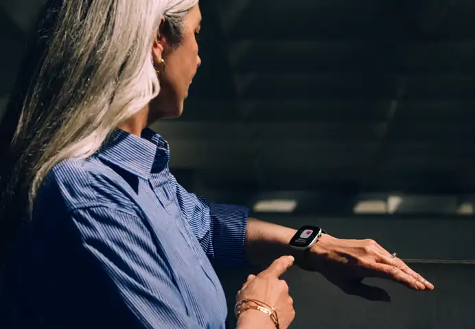 A person reads a Hypertension alert on her Apple Watch Series 11