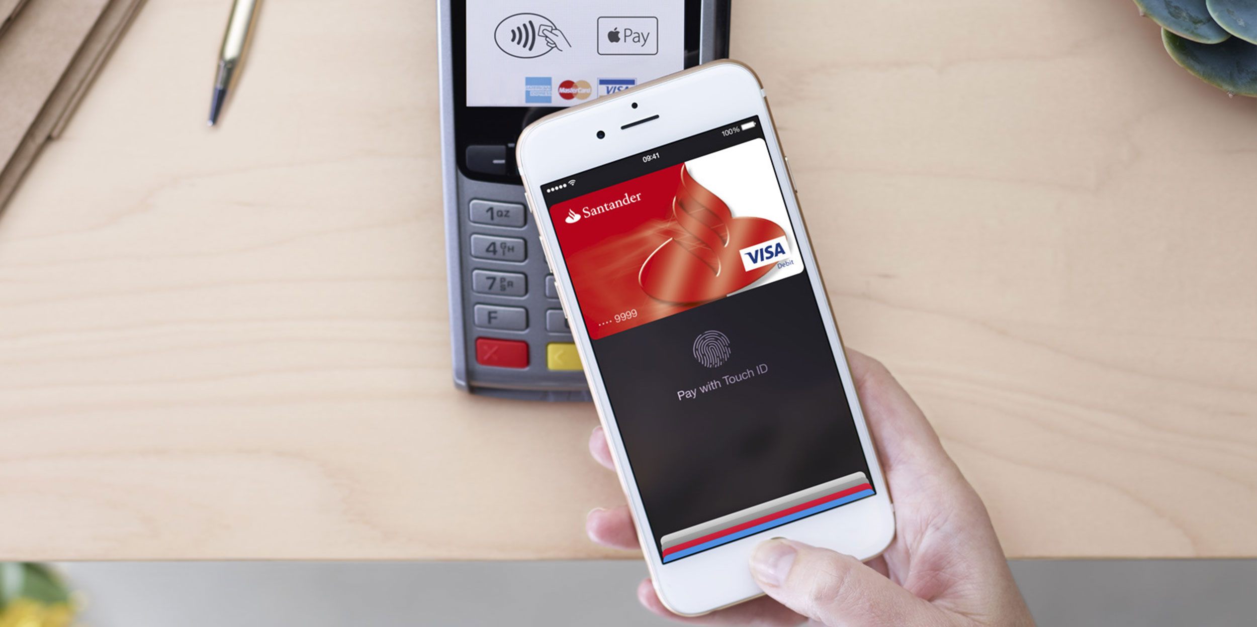 An iPhone using Apple Pay on a credit card reader.
