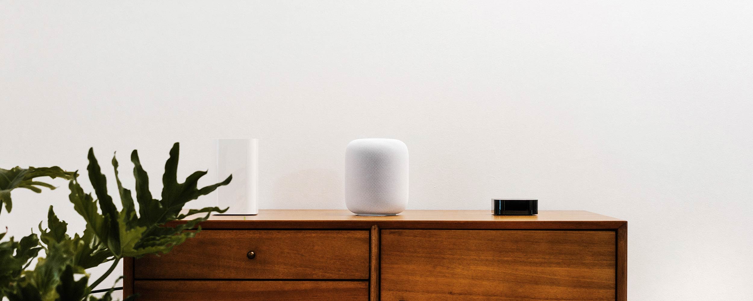 An array of smart speakers on a tabletop.